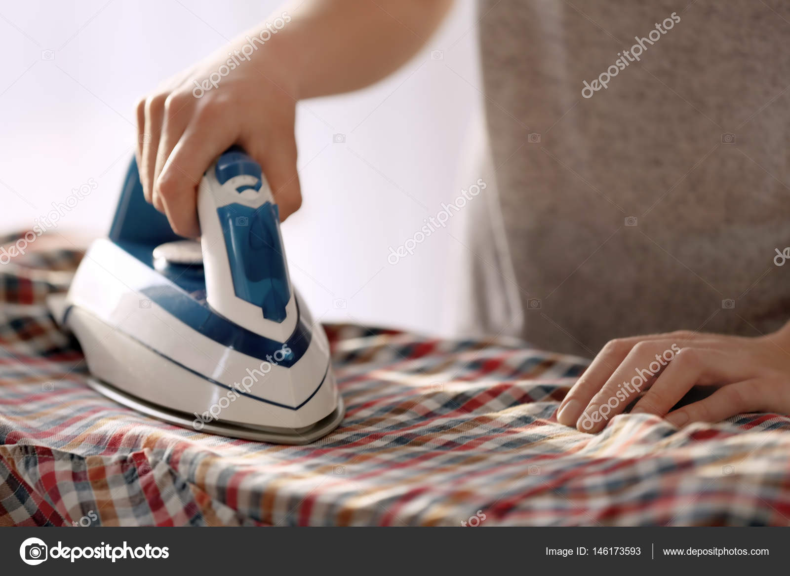 Woman ironing cloth Stock Photo by ©belchonock 146173593